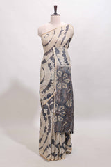 Beige linen cotton saree with grey shibori print, self zari border and floral design pallu