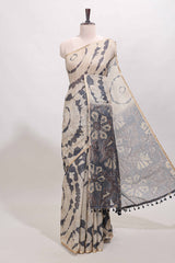Beige linen cotton saree with grey shibori print, self zari border and floral design pallu