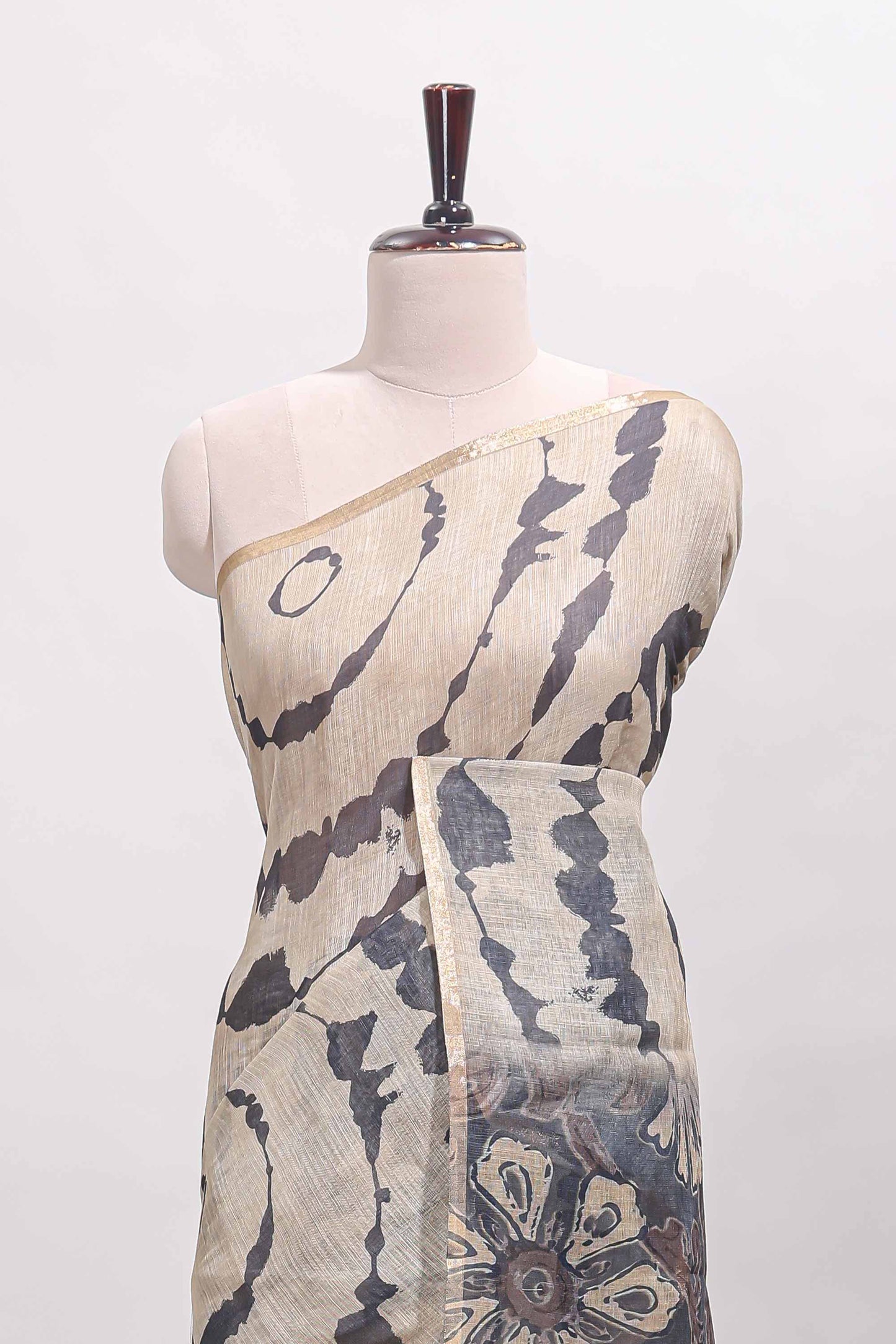 Beige linen cotton saree with grey shibori print, self zari border and floral design pallu