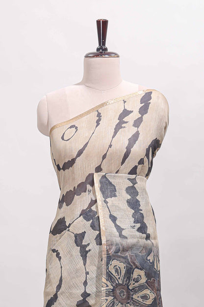 Beige linen cotton saree with grey shibori print, self zari border and floral design pallu
