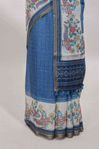 Blue checked linen cotton saree with bottom floral and birds design, self zari border and printed blouse