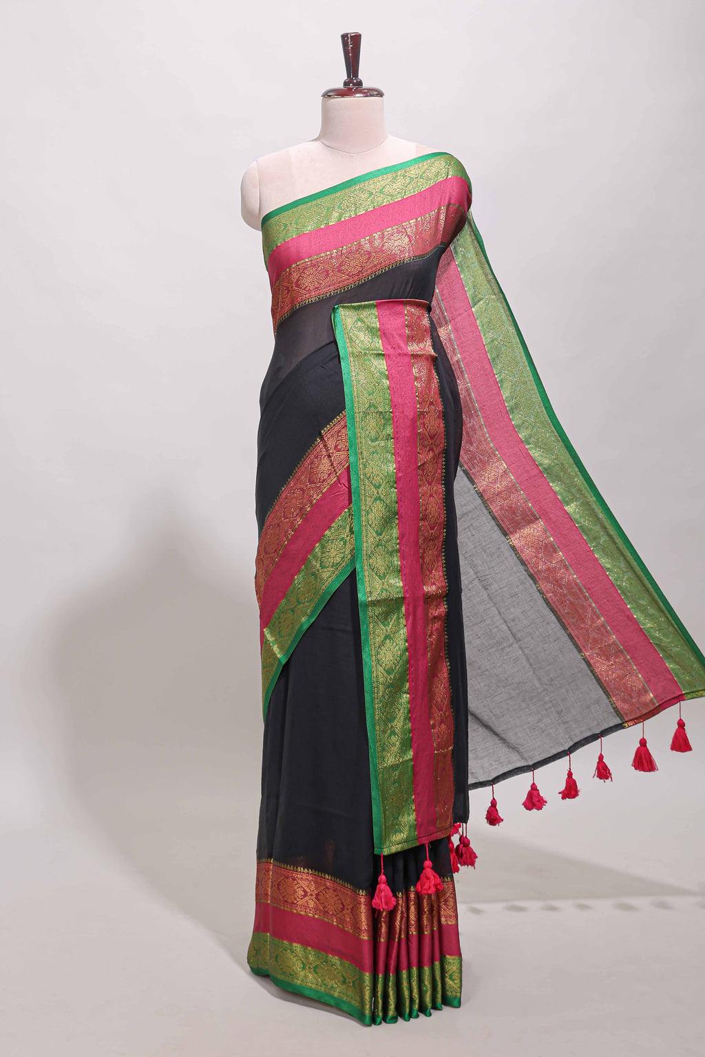 Black plain linen cotton saree with contrast zari bentex border & matching pallu with tassels