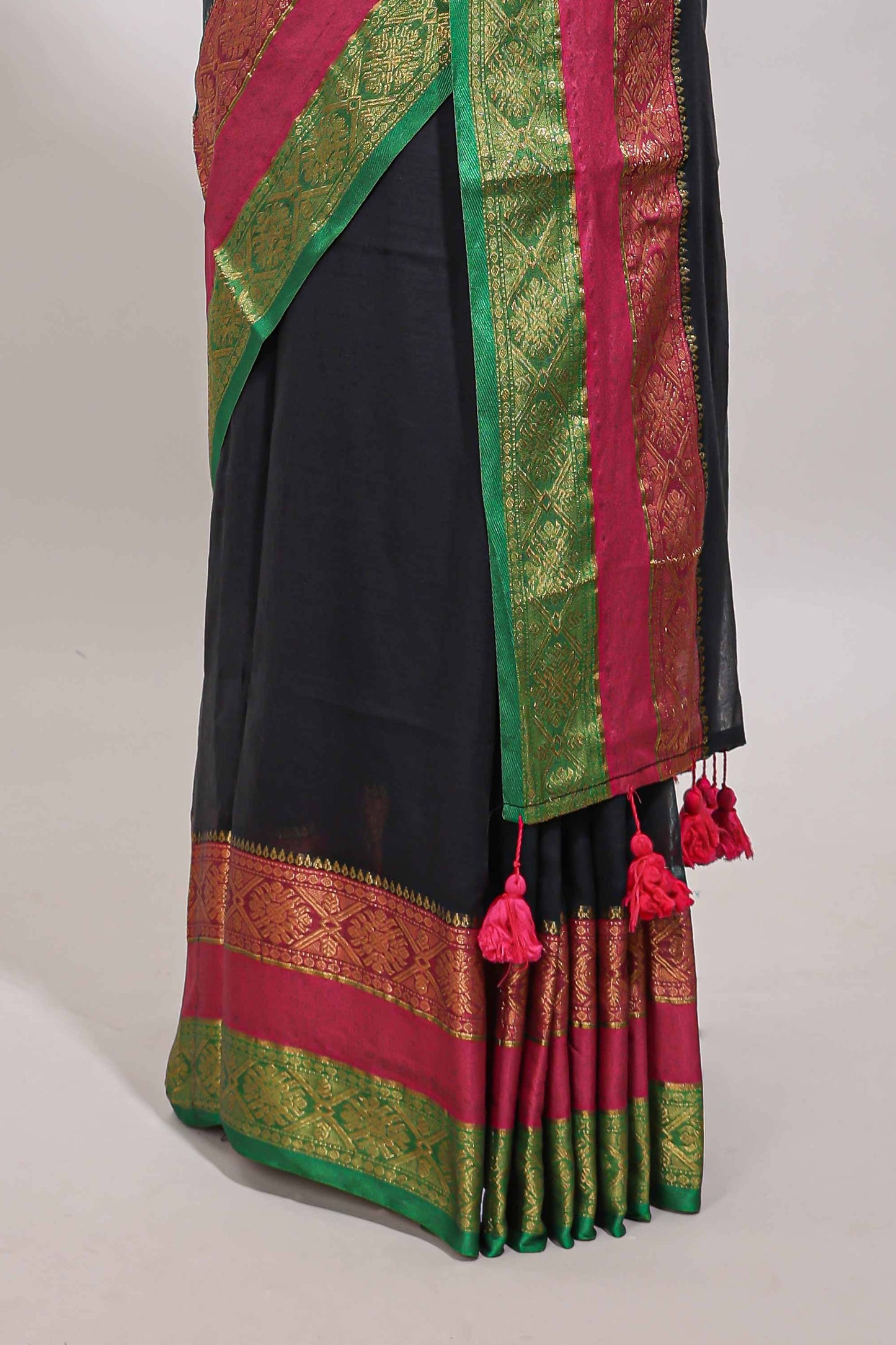 Black plain linen cotton saree with contrast zari bentex border & matching pallu with tassels