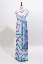 Off white chevron style shibori print linen cotton saree with contrast turquoise blue border and ikkat design pallu
