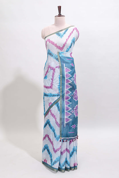 Off white chevron style shibori print linen cotton saree with contrast turquoise blue border and ikkat design pallu