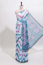 Off white chevron style shibori print linen cotton saree with contrast turquoise blue border and ikkat design pallu