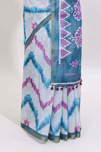 Off white chevron style shibori print linen cotton saree with contrast turquoise blue border and ikkat design pallu