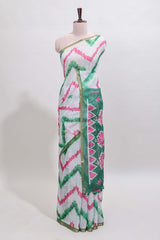 Off white chevron style shibori print linen cotton saree with contrast green border and ikkat design pallu