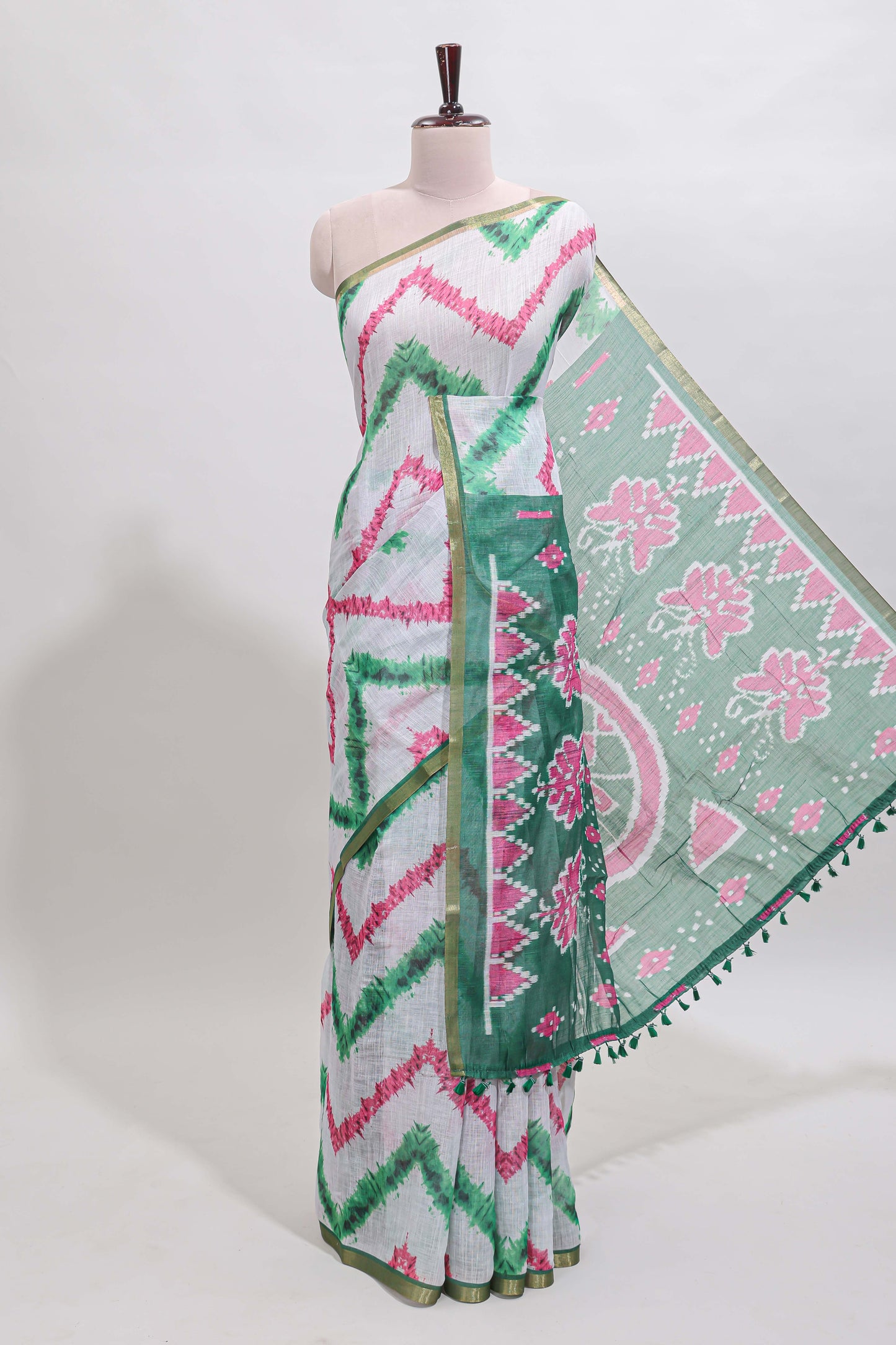 Off white chevron style shibori print linen cotton saree with contrast green border and ikkat design pallu