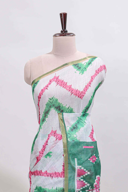 Off white chevron style shibori print linen cotton saree with contrast green border and ikkat design pallu