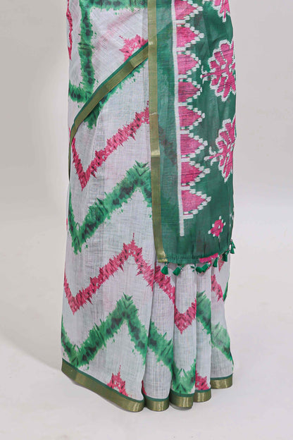 Off white chevron style shibori print linen cotton saree with contrast green border and ikkat design pallu
