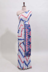 Off white chevron style shibori print linen cotton saree with contrast blue border and ikkat design pallu