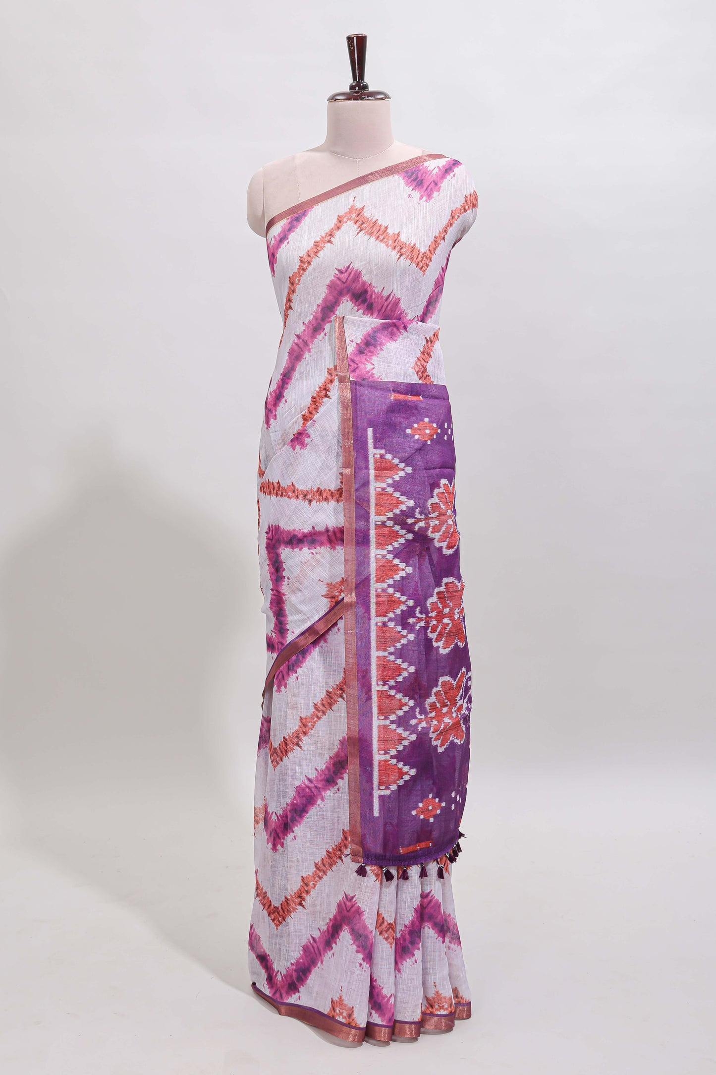Off white chevron style shibori print linen cotton saree with contrast purple border and ikkat design pallu