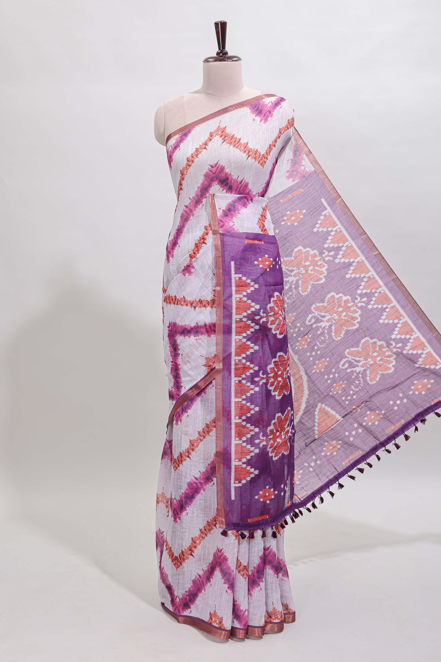 Off white chevron style shibori print linen cotton saree with contrast purple border and ikkat design pallu