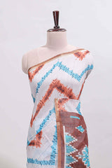 Off white chevron style shibori print linen cotton saree with contrast brown border and ikkat design pallu