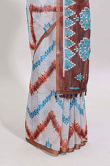 Off white chevron style shibori print linen cotton saree with contrast brown border and ikkat design pallu
