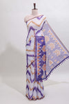 Off white chevron style shibori print linen cotton saree with contrast violet border and ikkat design pallu