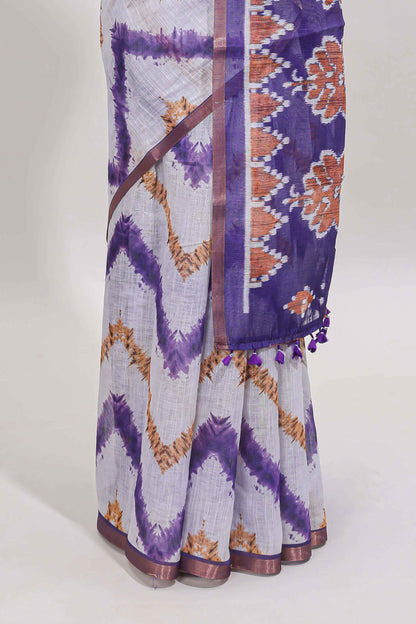 Off white chevron style shibori print linen cotton saree with contrast violet border and ikkat design pallu