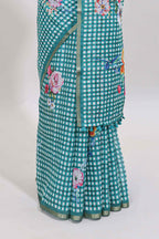 Green checked floral design linen cotton saree with self zari border and printed blouse