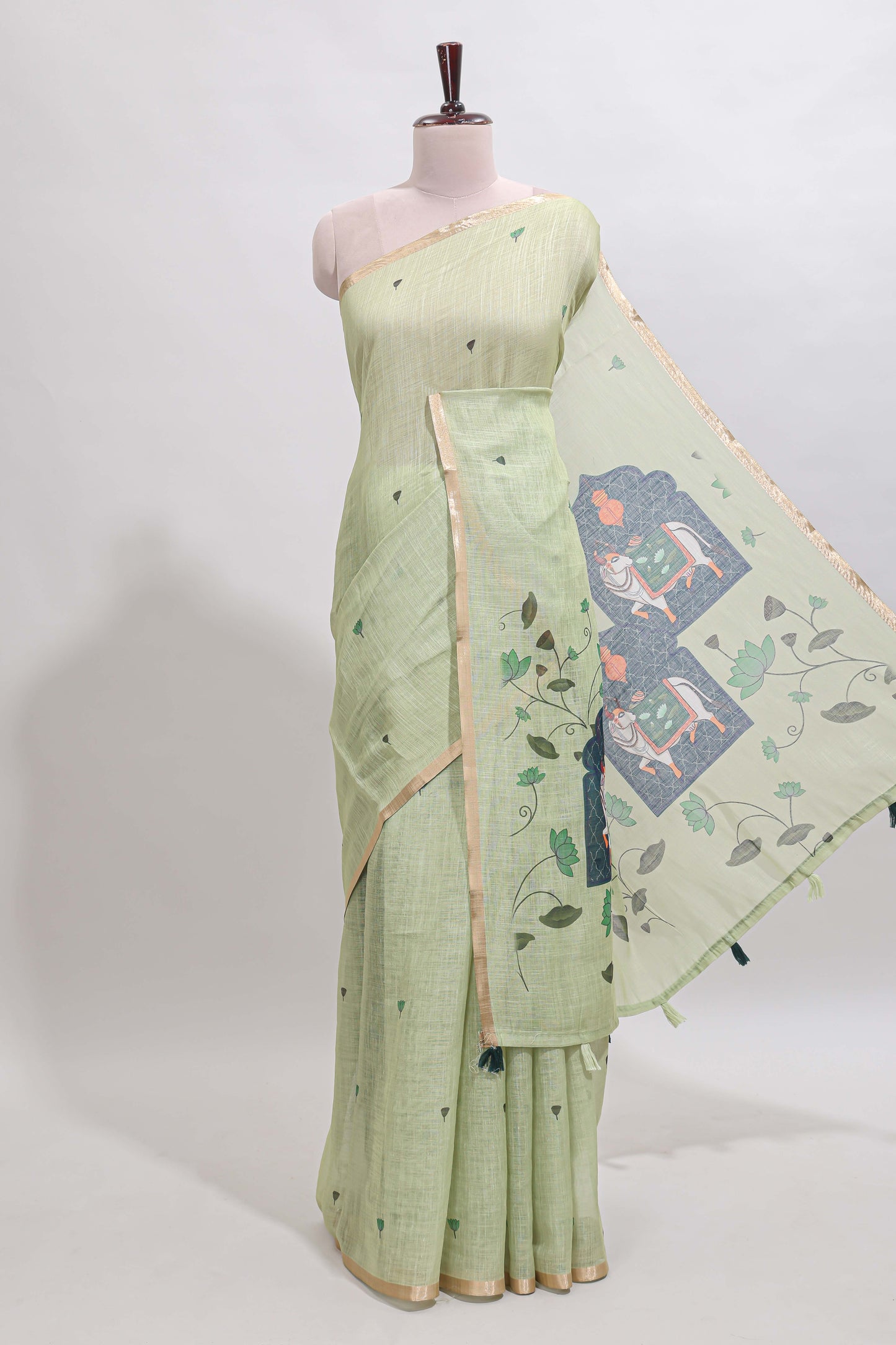 Green floral design linen cotton saree with self zari border, matching pallu and contrast blouse