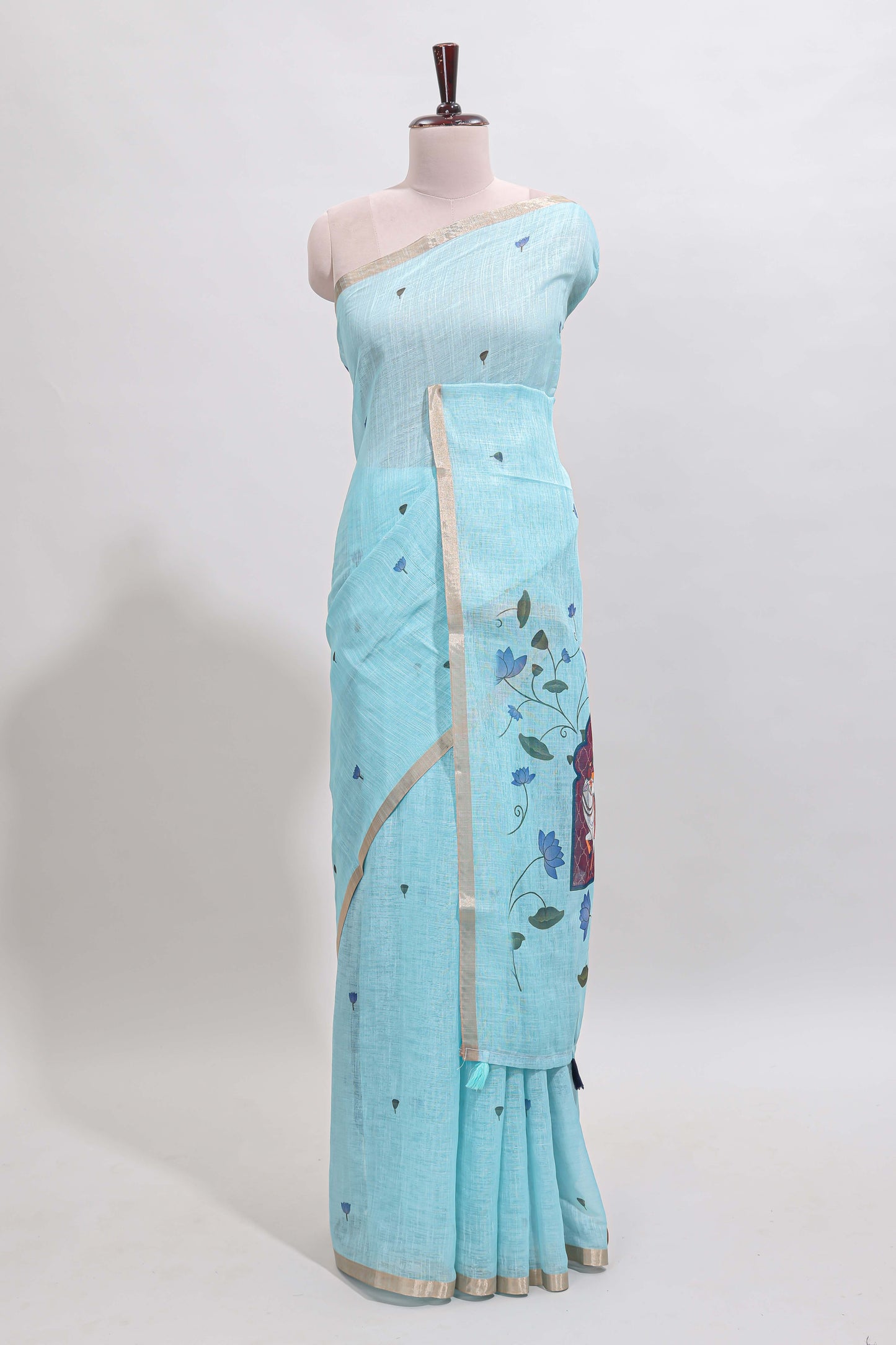 Blue floral design linen cotton saree with self zari border, matching pallu and contrast blouse