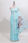 Blue floral design linen cotton saree with self zari border, matching pallu and contrast blouse