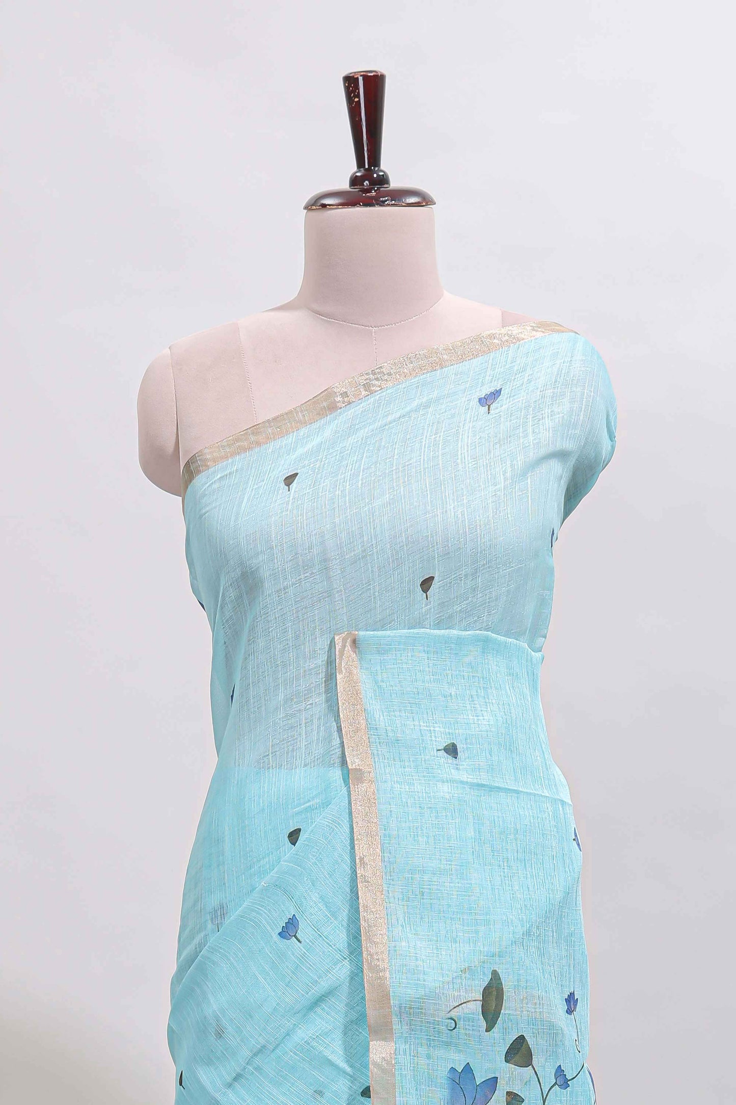 Blue floral design linen cotton saree with self zari border, matching pallu and contrast blouse