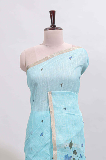 Blue floral design linen cotton saree with self zari border, matching pallu and contrast blouse