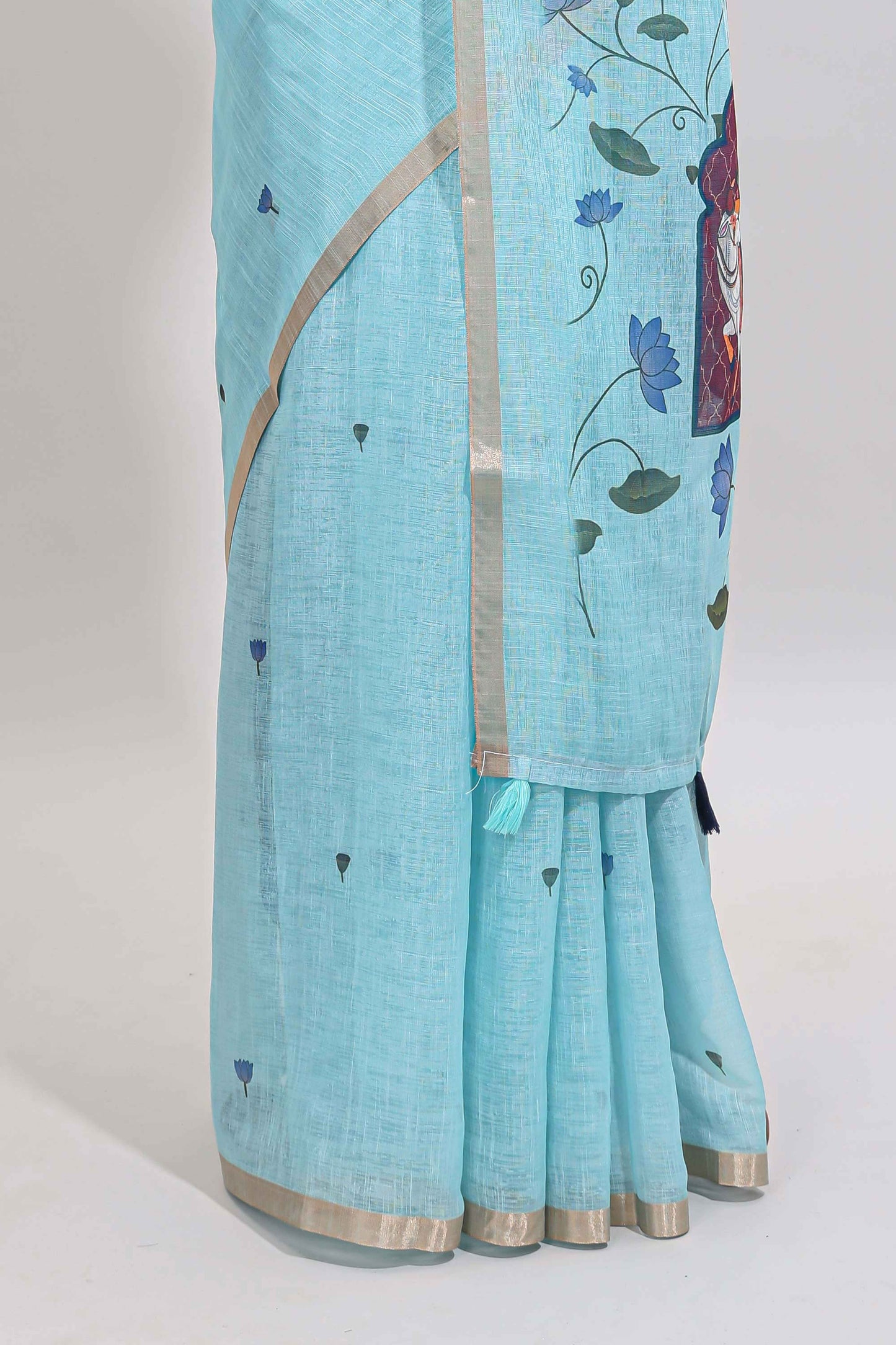 Blue floral design linen cotton saree with self zari border, matching pallu and contrast blouse
