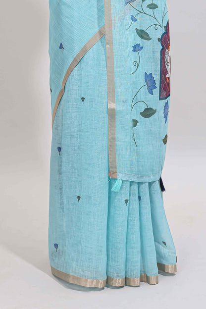 Blue floral design linen cotton saree with self zari border, matching pallu and contrast blouse