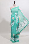 Turquoise green winter themed linen cotton saree with self border and matching blouse