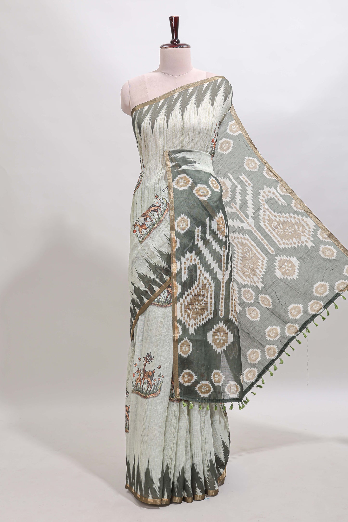 Green deer & fawn motifs linen cotton saree with self zari border and contrast ikkat style pallu