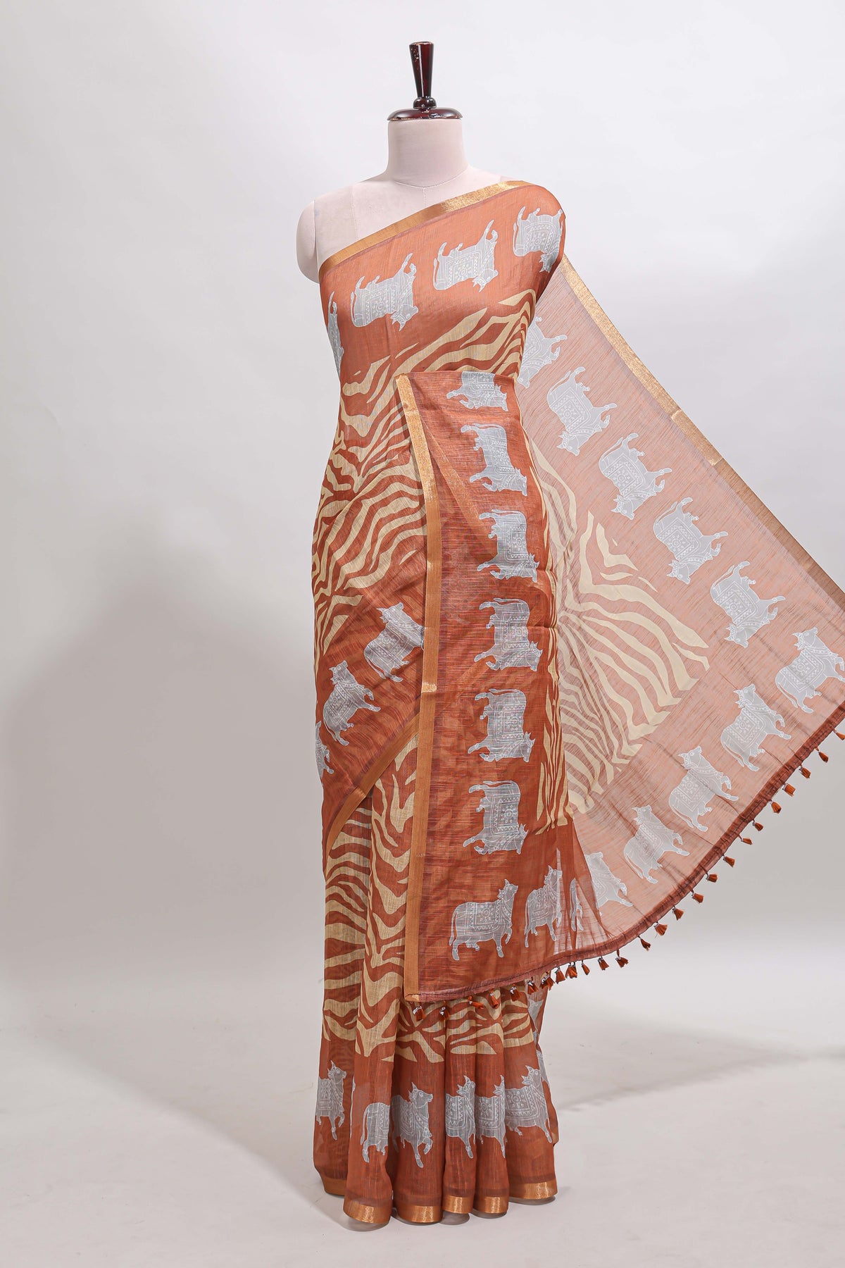 Brown pichwai cow prints & Zebra inspired pattern linen cotton saree with self zari border and matching blouse
