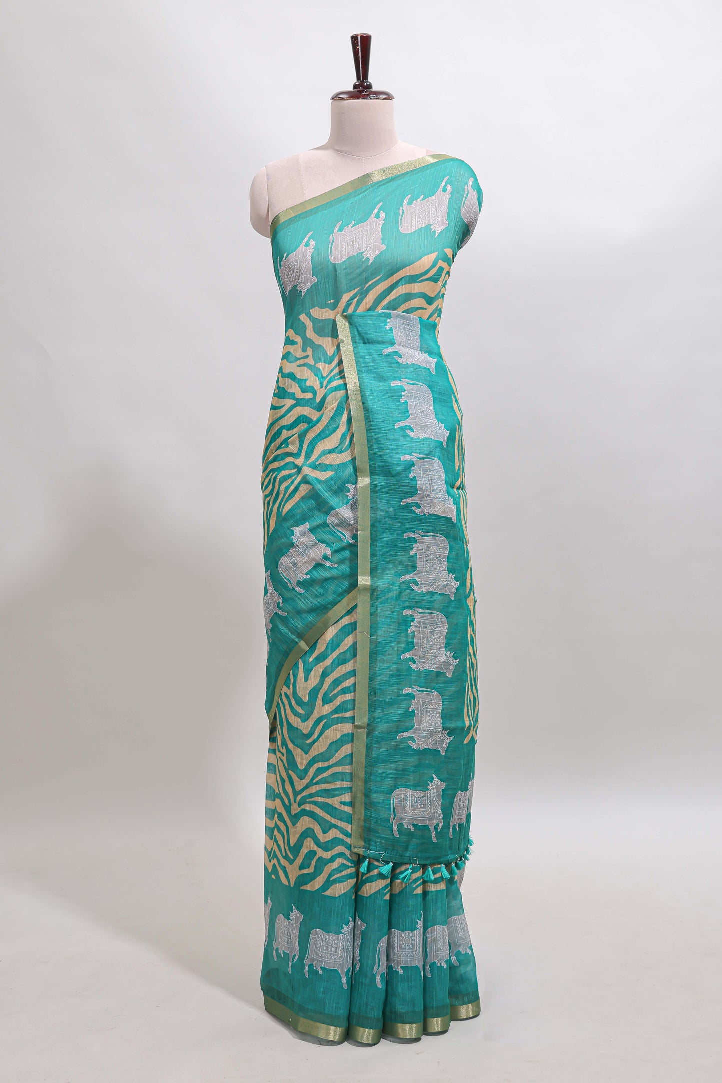 Turquoise green pichwai cow prints & Zebra inspired pattern linen cotton saree with self zari border and matching blouse