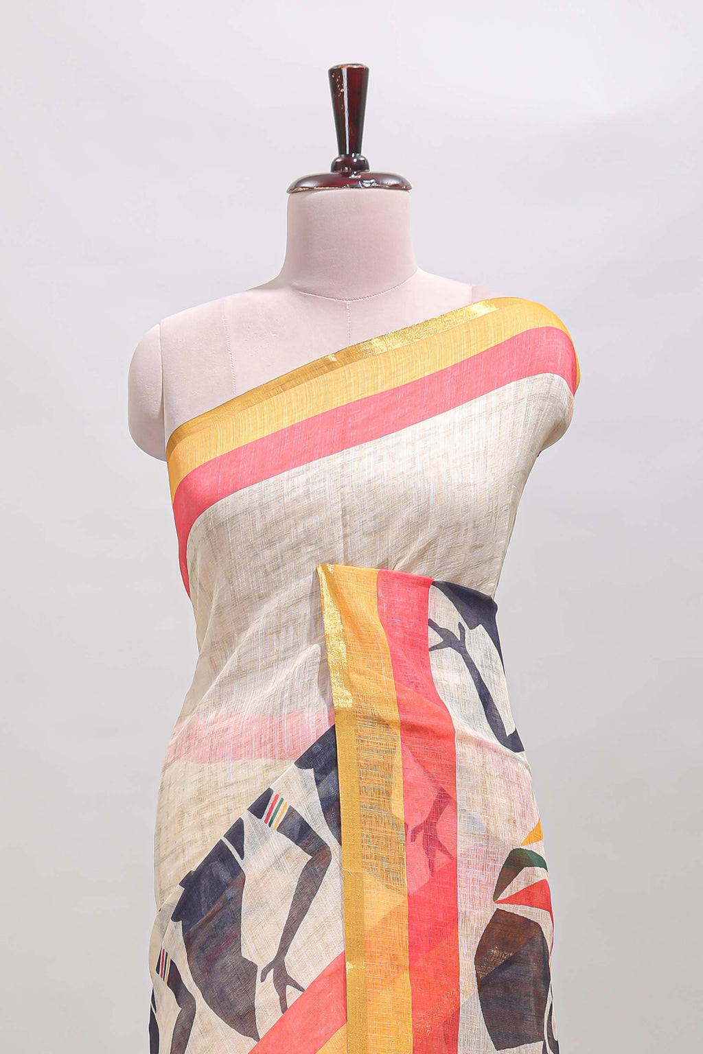Beige artistic traditional tribal print linen cotton saree with contrast border and multi color blouse