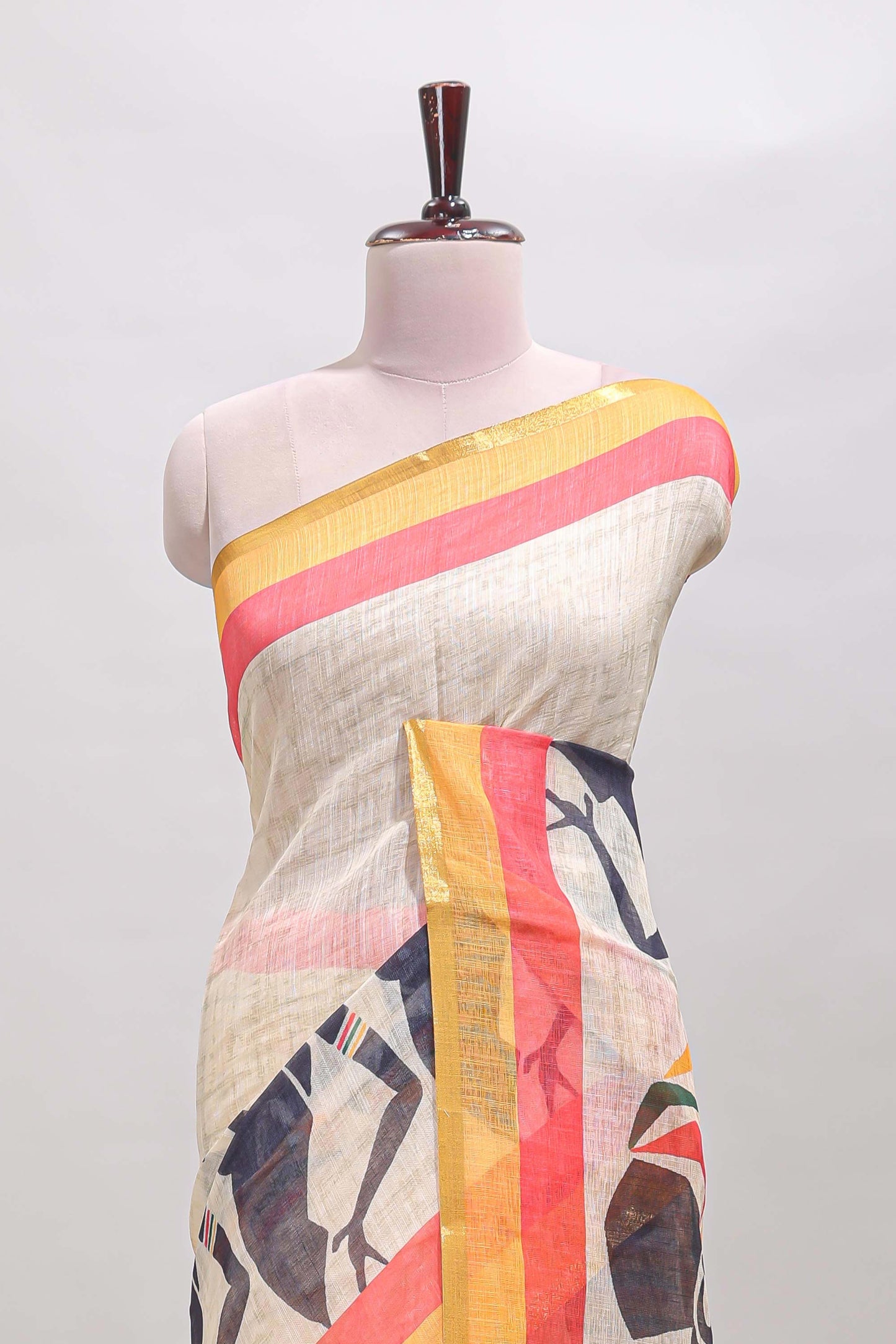 Beige artistic traditional tribal print linen cotton saree with contrast border and multi color blouse