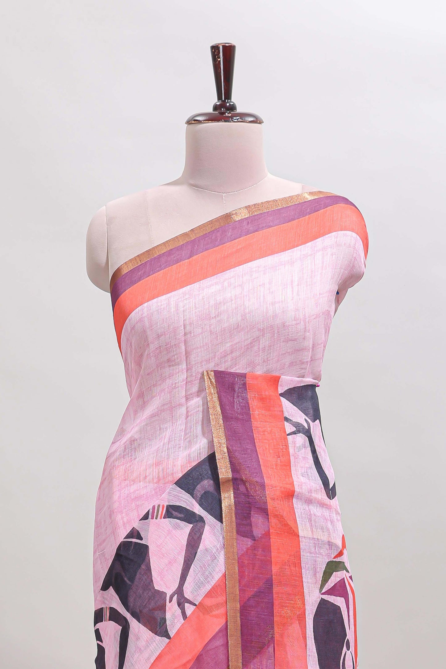Light pink artistic traditional tribal print linen cotton saree with contrast border and striped blouse