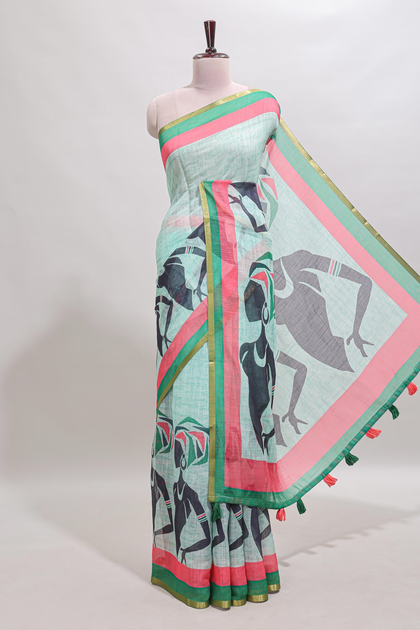Light green artistic traditional tribal print linen cotton saree with contrast border and striped blouse