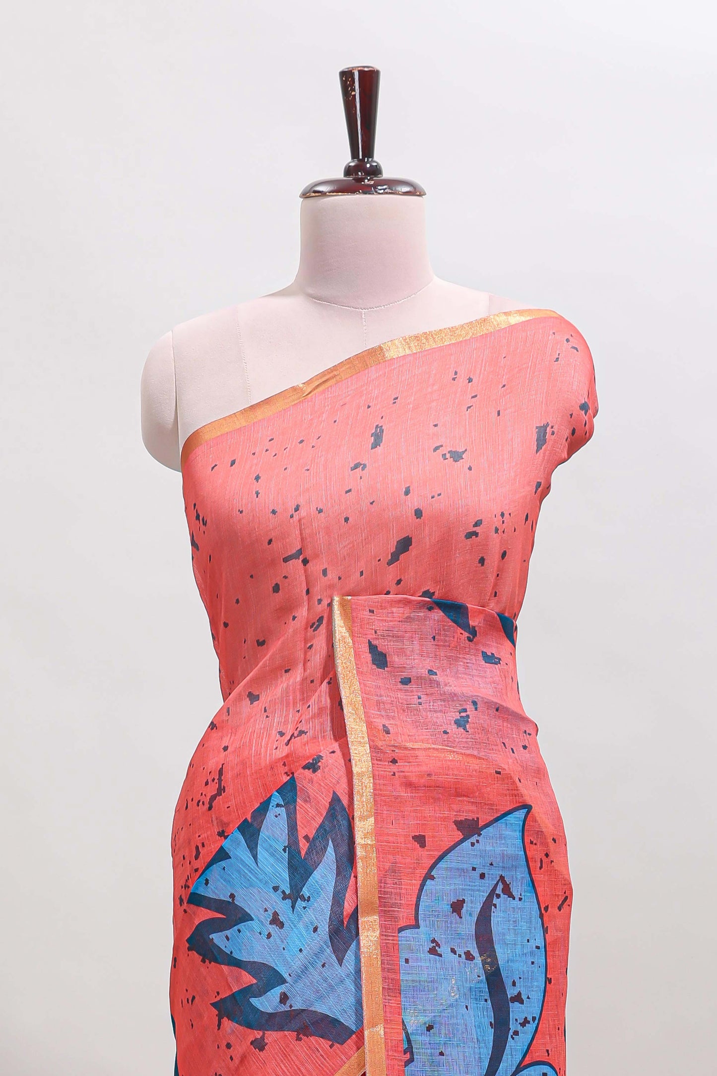 Orange floral design linen cotton saree with self zari border and contrast blouse