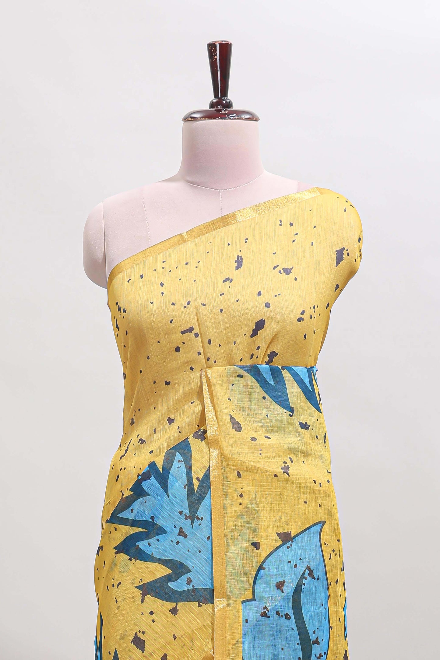 Yellow floral design linen cotton saree with self zari border and contrast blouse