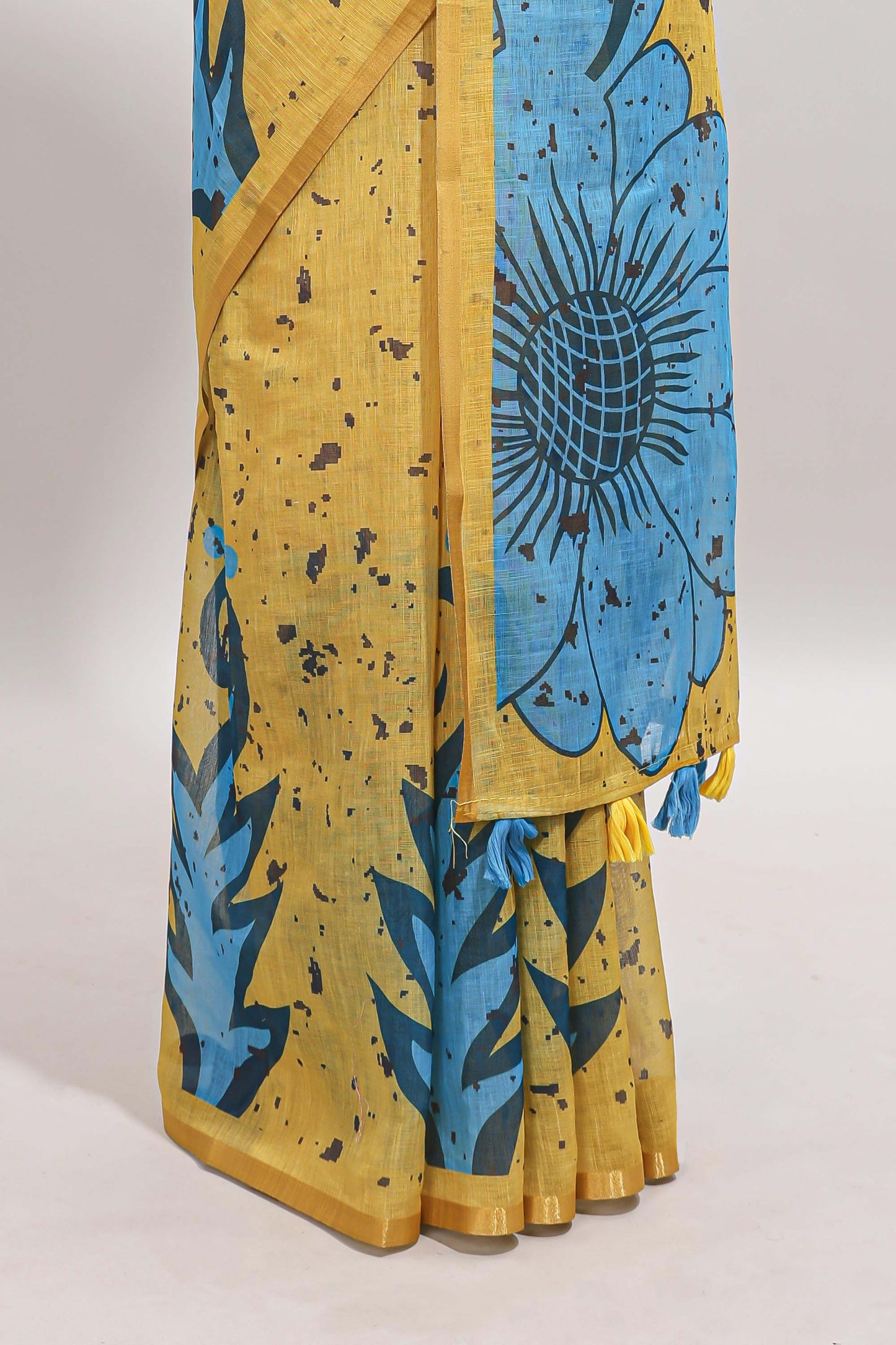 Yellow floral design linen cotton saree with self zari border and contrast blouse
