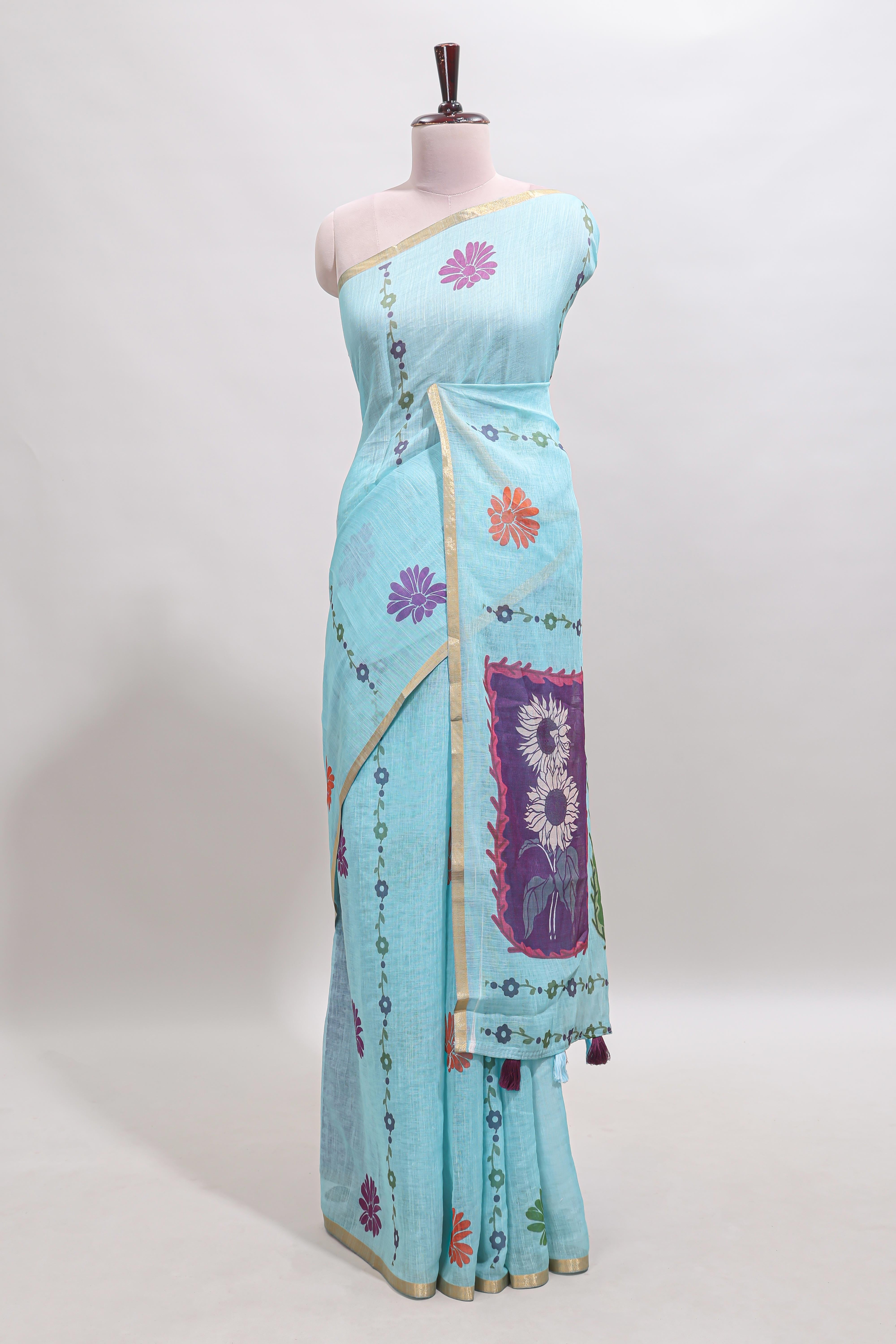 Blue floral design linen cotton saree with self zari border and contrast blouse