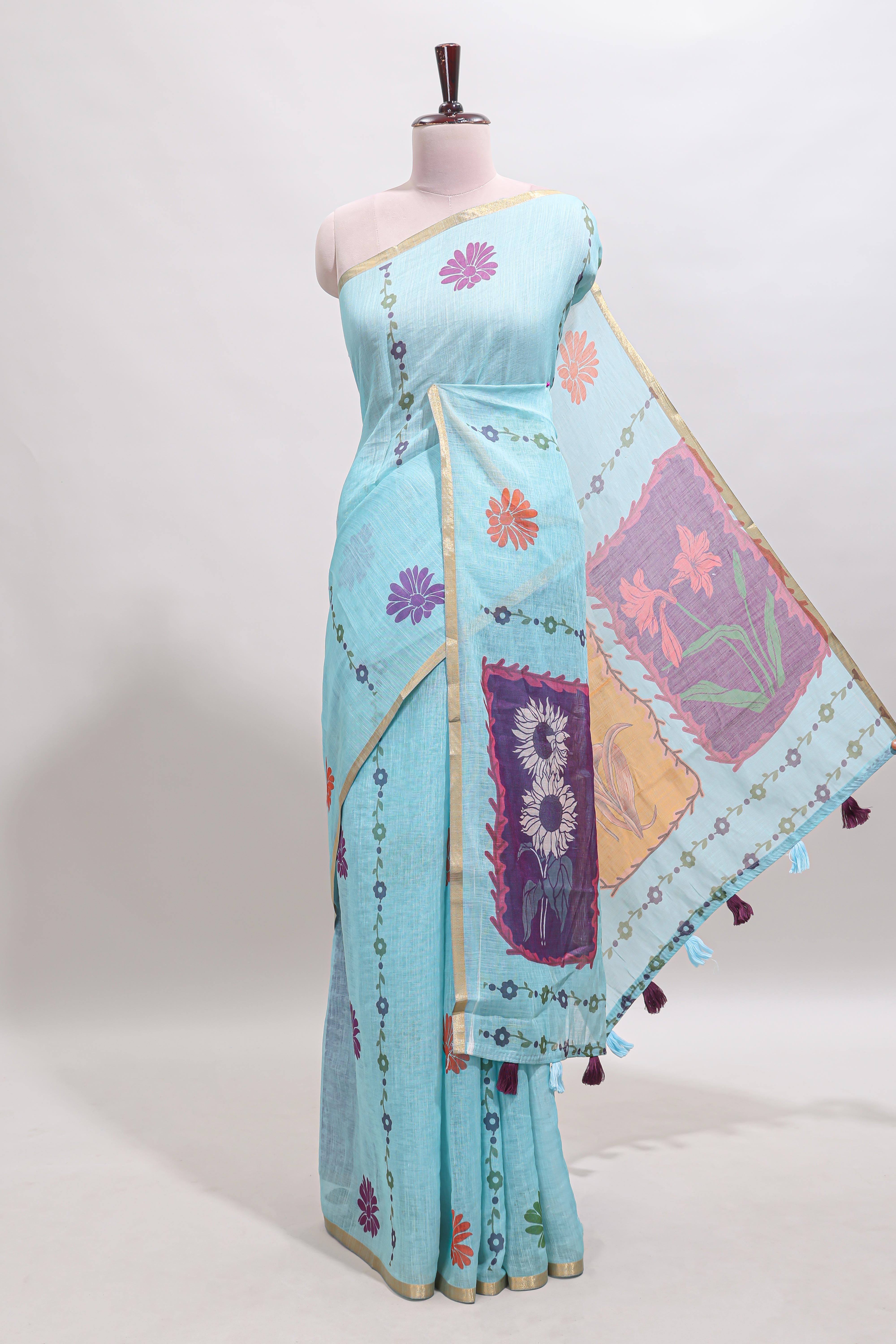 Blue floral design linen cotton saree with self zari border and contrast blouse