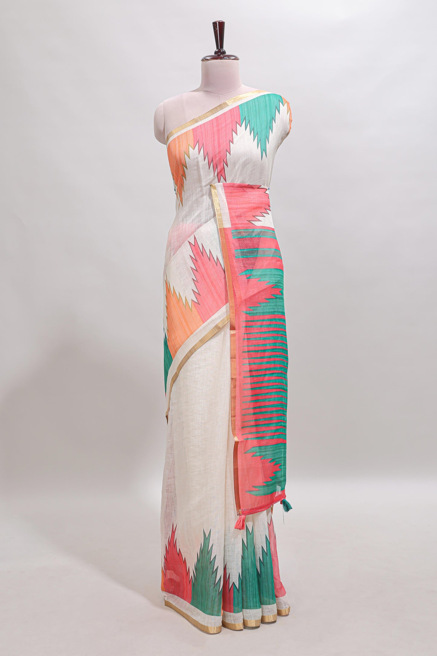 Cream ikkat style linen cotton saree with self zari border and contrast blouse