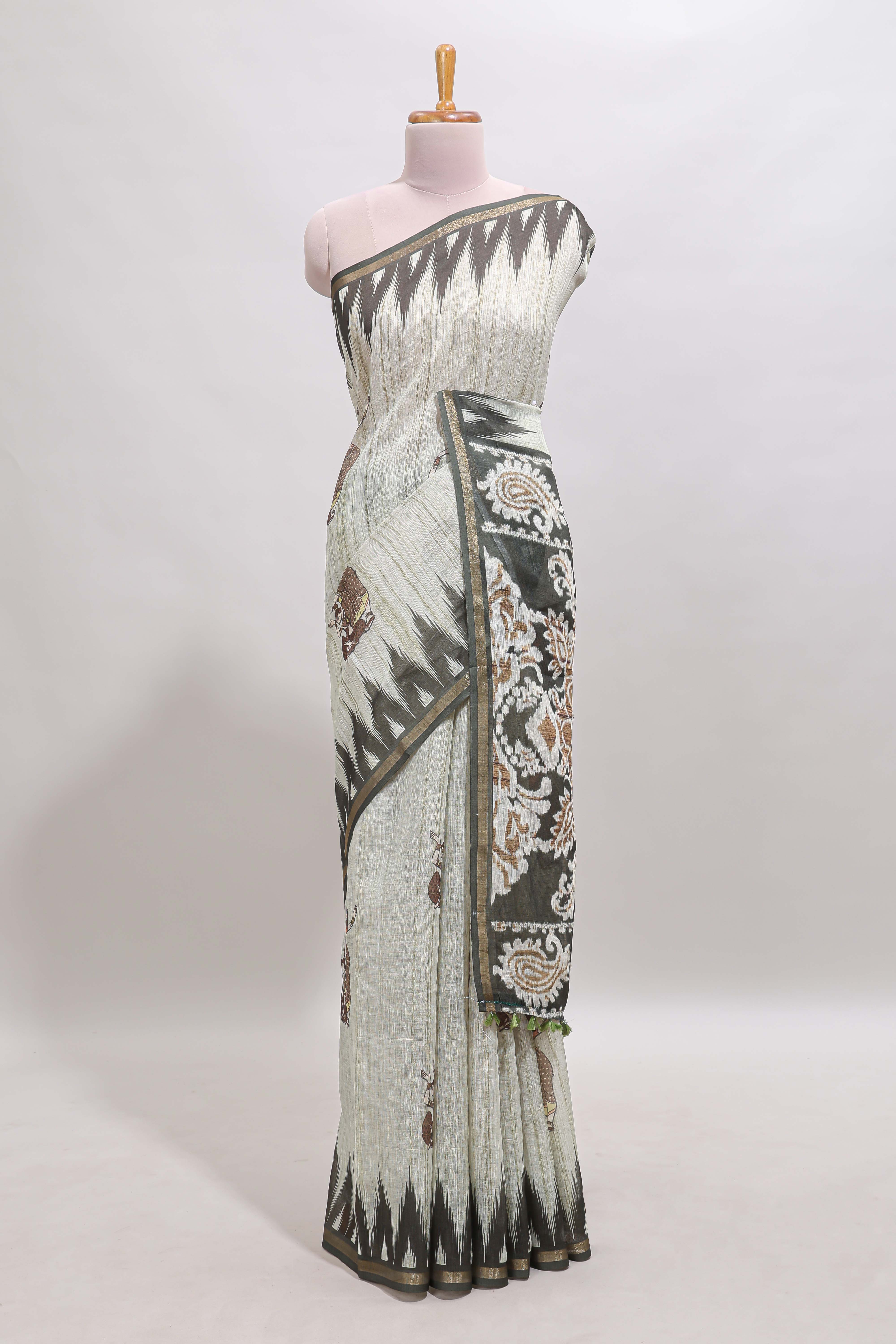 Green tribal dance dance motifs linen cotton saree with contrast ikkat border and printed pallu