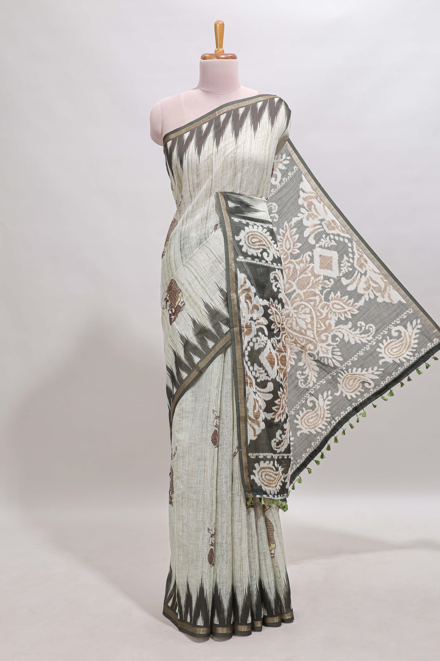 Green tribal dance dance motifs linen cotton saree with contrast ikkat border and printed pallu