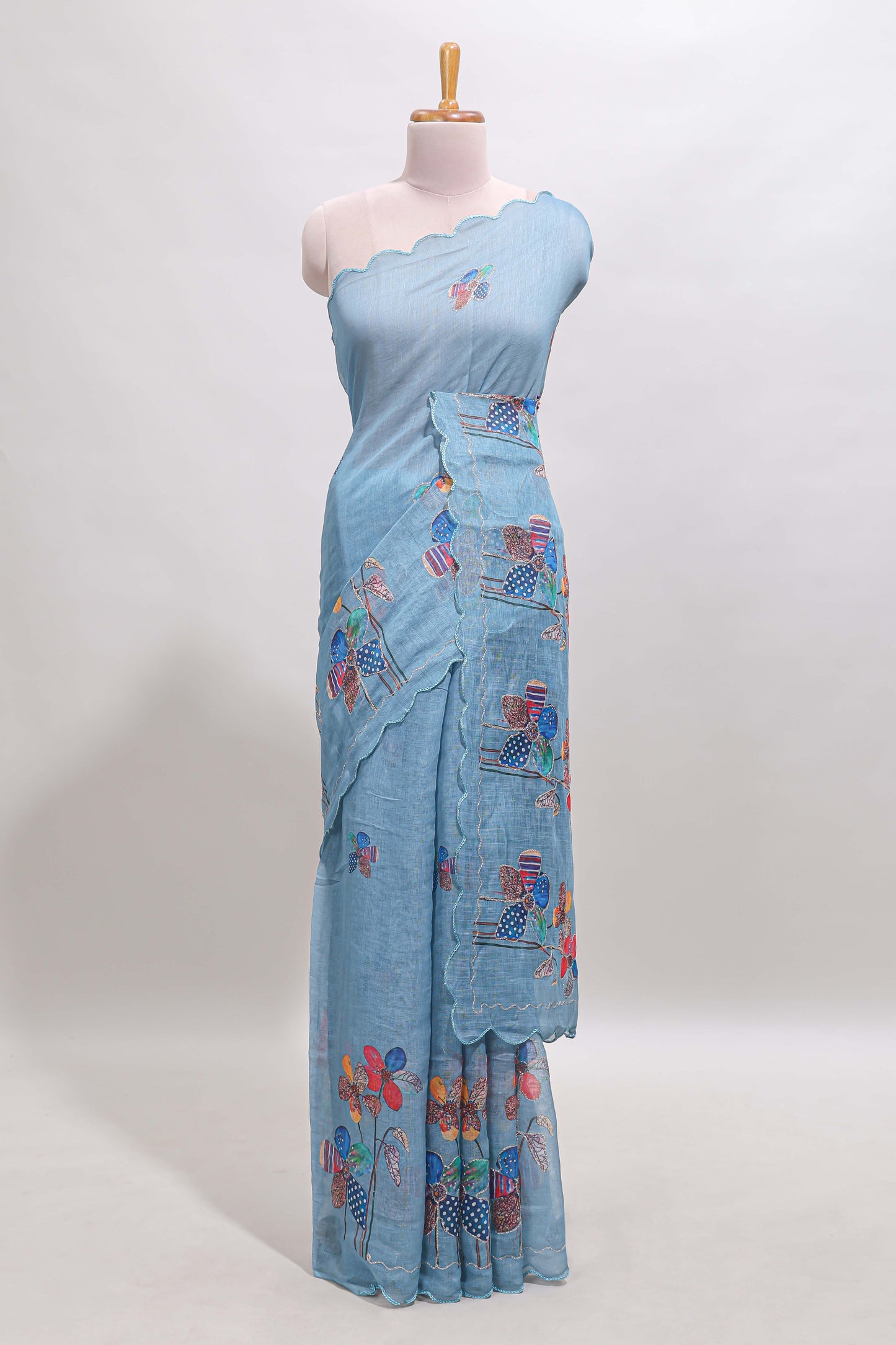 Blue floral design linen cotton saree with scallop border and matching printed blouse