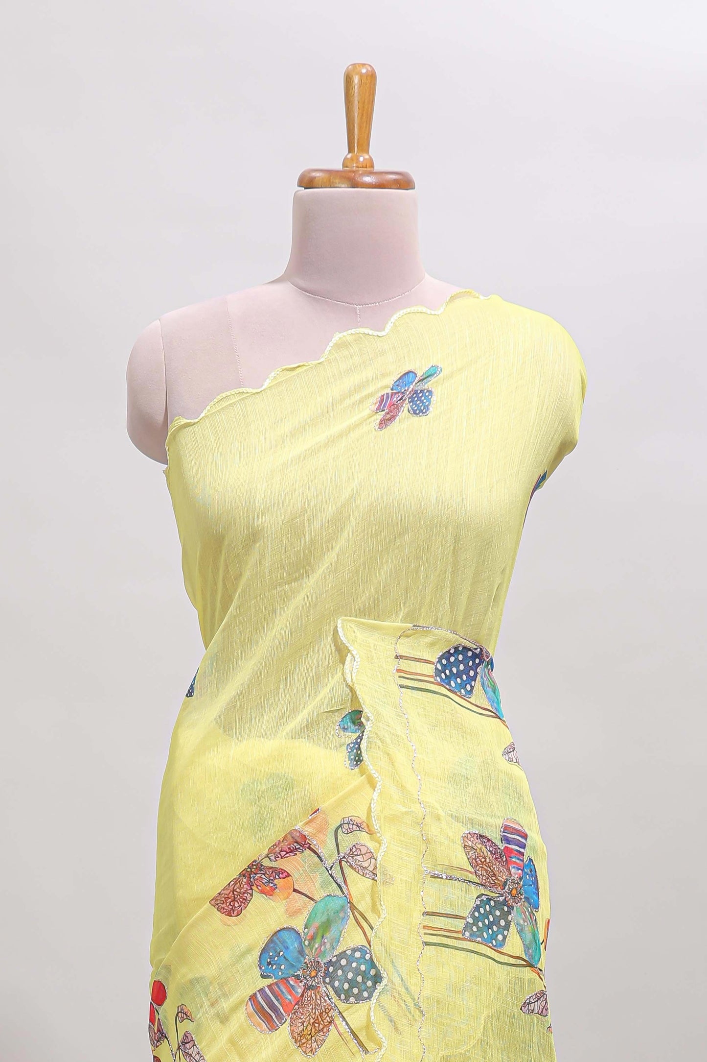 Yellow floral design linen cotton saree with scallop border and matching printed blouse