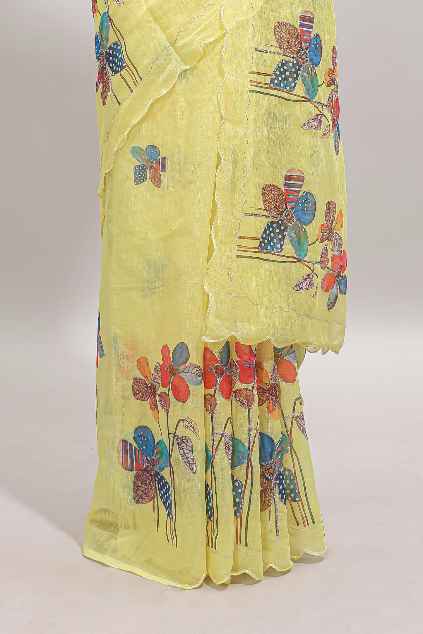 Yellow floral design linen cotton saree with scallop border and matching printed blouse