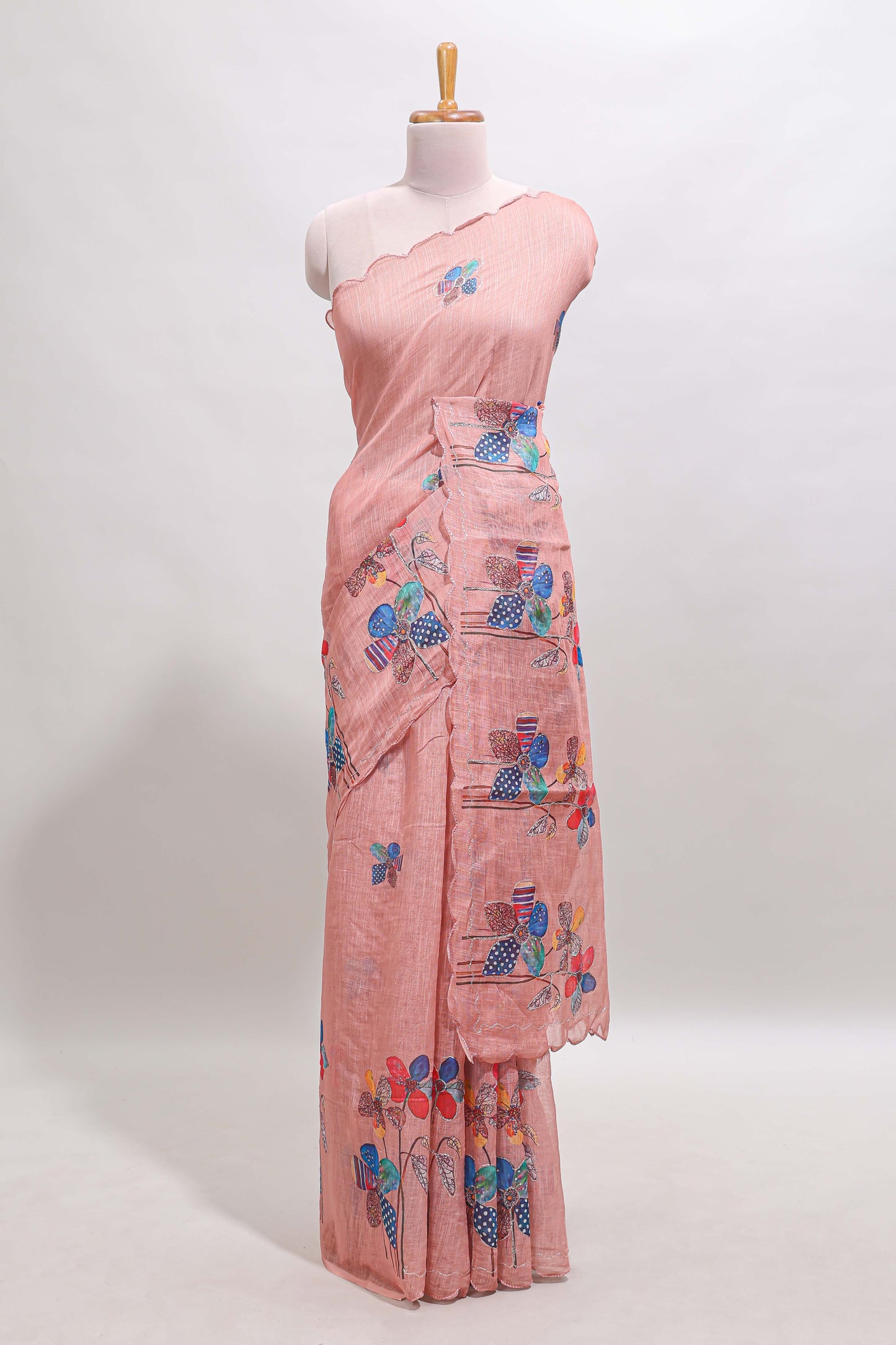 Peach floral design linen cotton saree with scallop border and matching printed blouse